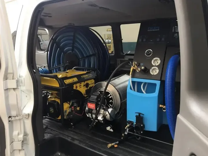A truck-mounted extraction unit with its hose reel ready to go