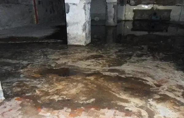 Groundwater spreading over a basement floor along the foundation wall